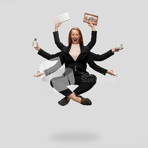 Image of Beautiful business woman, secretary, multi-armed manager levitating isolated on grey studio background