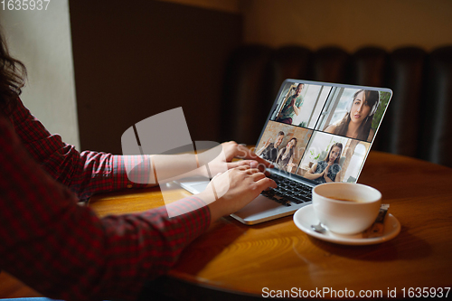 Image of Remote working. Workplace in bar, restaurant office with PC, devices and gadgets.