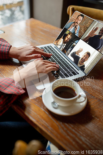 Image of Remote working. Workplace in bar, restaurant office with PC, devices and gadgets.