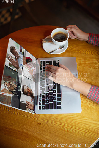 Image of Remote working. Workplace in bar, restaurant office with PC, devices and gadgets.