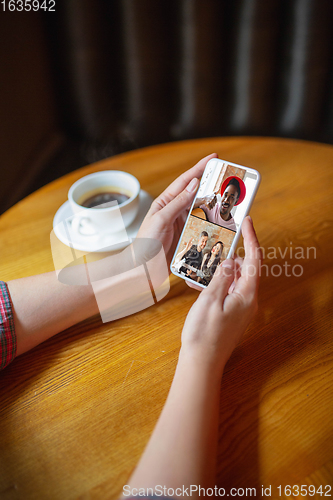 Image of Remote working. Workplace in bar, restaurant office with PC, devices and gadgets.