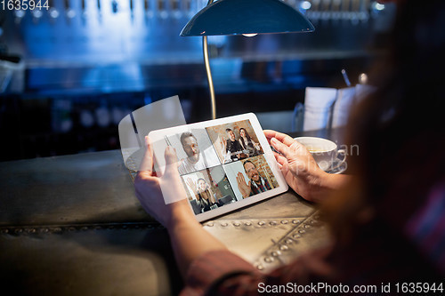 Image of Remote working. Workplace in bar, restaurant office with PC, devices and gadgets.