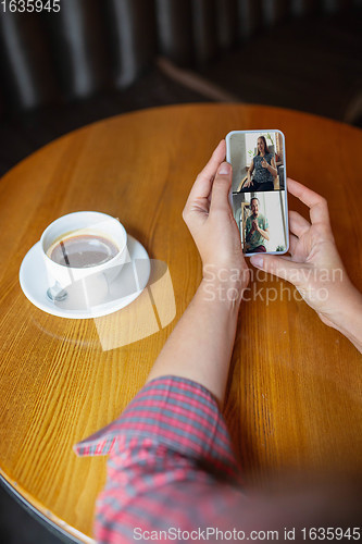 Image of Remote working. Workplace in bar, restaurant office with PC, devices and gadgets.