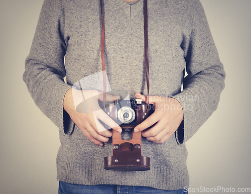 Image of Man holiding retro camera