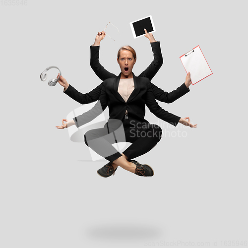 Image of Beautiful business woman, secretary, multi-armed manager levitating isolated on grey studio background