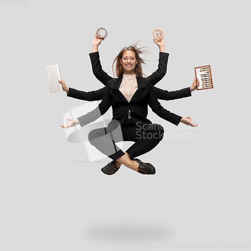 Image of Beautiful business woman, secretary, multi-armed manager levitating isolated on grey studio background