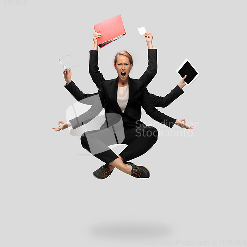 Image of Beautiful business woman, secretary, multi-armed manager levitating isolated on grey studio background