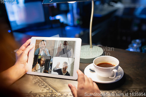 Image of Remote working. Workplace in bar, restaurant office with PC, devices and gadgets.