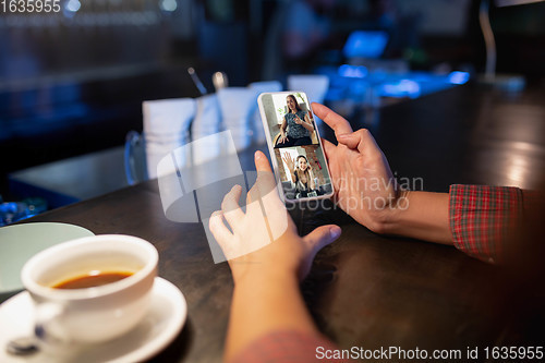 Image of Remote working. Workplace in bar, restaurant office with PC, devices and gadgets.