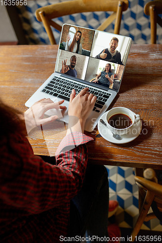 Image of Remote working. Workplace in bar, restaurant office with PC, devices and gadgets.