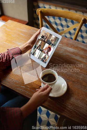 Image of Remote working. Workplace in bar, restaurant office with PC, devices and gadgets.