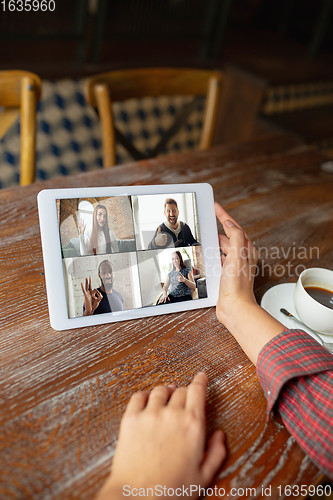 Image of Remote working. Workplace in bar, restaurant office with PC, devices and gadgets.