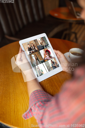 Image of Remote working. Workplace in bar, restaurant office with PC, devices and gadgets.