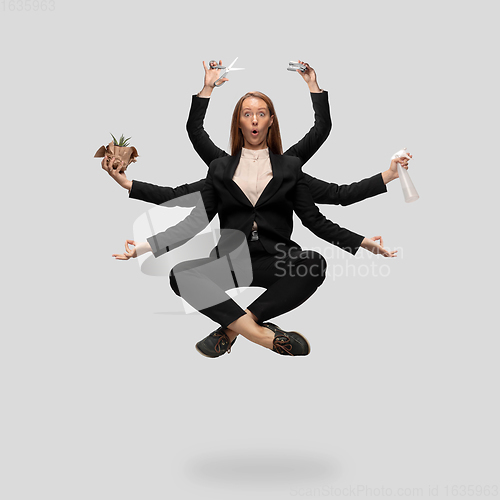 Image of Beautiful business woman, secretary, multi-armed manager levitating isolated on grey studio background