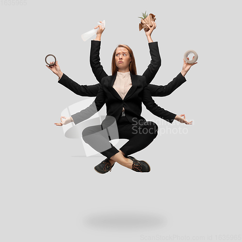 Image of Beautiful business woman, secretary, multi-armed manager levitating isolated on grey studio background