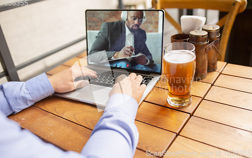 Image of Remote working, online entertainment during quarantine. Remote events in bar, restaurant office with PC, devices and gadgets.