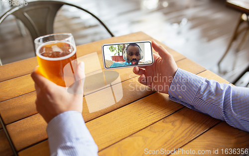 Image of Remote working, online entertainment during quarantine. Remote events in bar, restaurant office with PC, devices and gadgets.