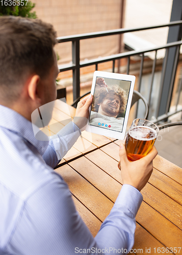 Image of Remote working, online entertainment during quarantine. Remote events in bar, restaurant office with PC, devices and gadgets.