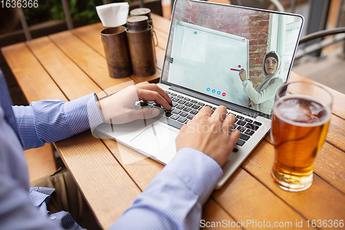 Image of Remote working, online entertainment during quarantine. Remote events in bar, restaurant office with PC, devices and gadgets.