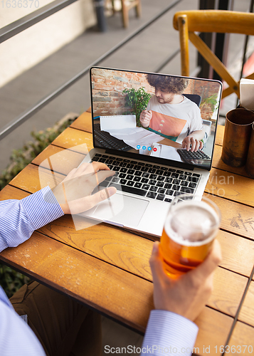 Image of Remote working, online entertainment during quarantine. Remote events in bar, restaurant office with PC, devices and gadgets.