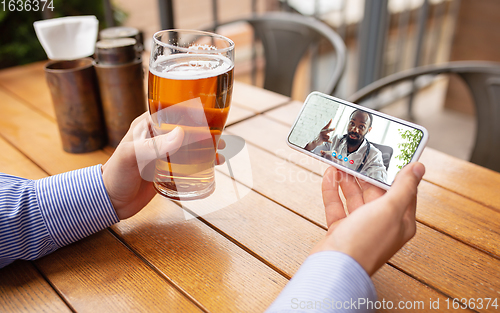 Image of Remote working, online entertainment during quarantine. Remote events in bar, restaurant office with PC, devices and gadgets.