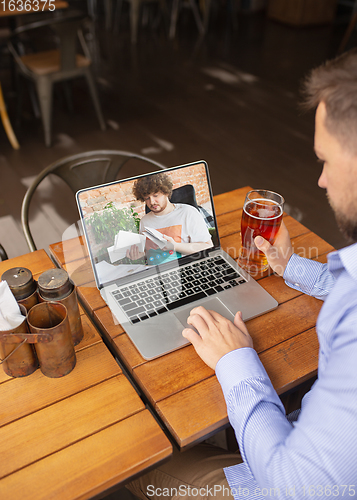 Image of Remote working, online entertainment during quarantine. Remote events in bar, restaurant office with PC, devices and gadgets.