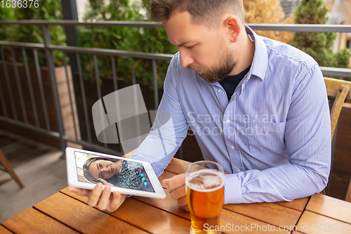 Image of Remote working, online entertainment during quarantine. Remote events in bar, restaurant office with PC, devices and gadgets.