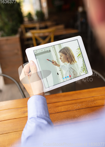 Image of Remote working, online entertainment during quarantine. Remote events in bar, restaurant office with PC, devices and gadgets.