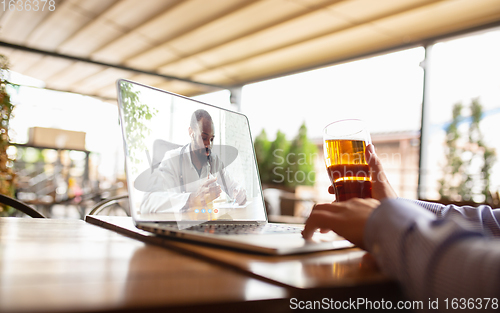 Image of Remote working, online entertainment during quarantine. Remote events in bar, restaurant office with PC, devices and gadgets.