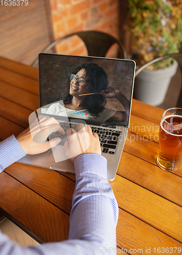 Image of Remote working, online entertainment during quarantine. Remote events in bar, restaurant office with PC, devices and gadgets.