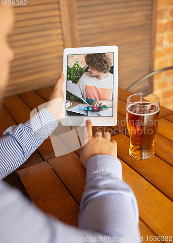 Image of Remote working, online entertainment during quarantine. Remote events in bar, restaurant office with PC, devices and gadgets.