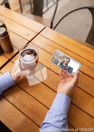 Image of Remote working, online entertainment during quarantine. Remote events in bar, restaurant office with PC, devices and gadgets.