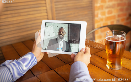 Image of Remote working, online entertainment during quarantine. Remote events in bar, restaurant office with PC, devices and gadgets.