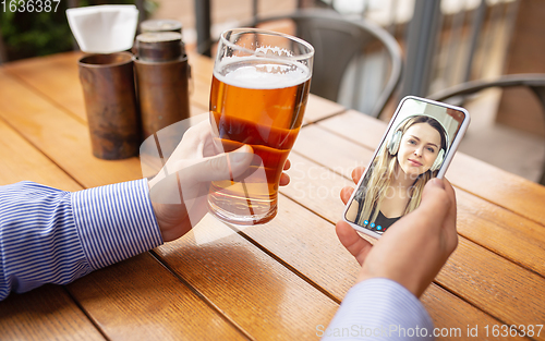 Image of Remote working, online entertainment during quarantine. Remote events in bar, restaurant office with PC, devices and gadgets.