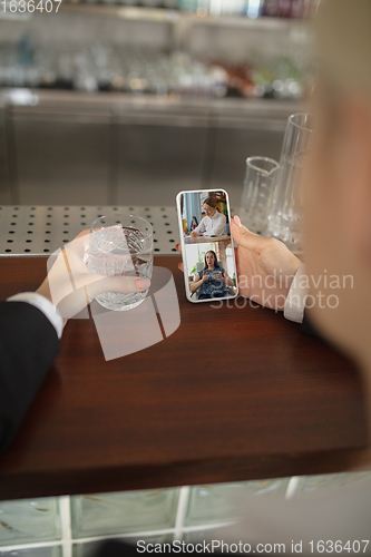 Image of Remote working. Workplace in bar, restaurant office with PC, devices and gadgets.