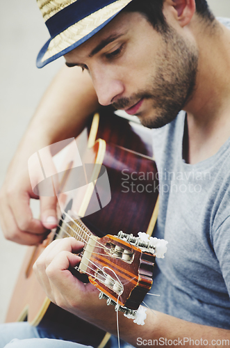 Image of Man plays the guitar