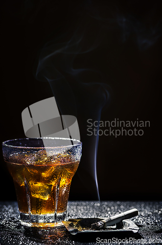 Image of Glass of cold drink and tobacco