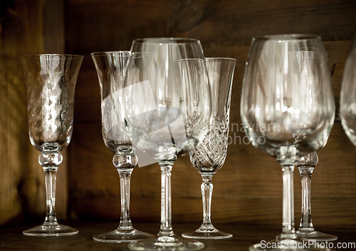 Image of glasses on the shelf of an old cabinet