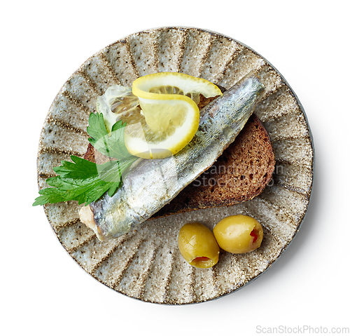 Image of canned sardine on bread slice