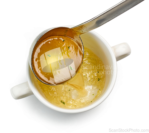 Image of chicken broth pouring into bowl