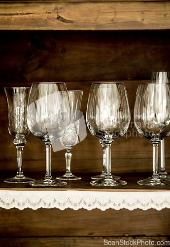 Image of glasses on the shelf of an old cabinet