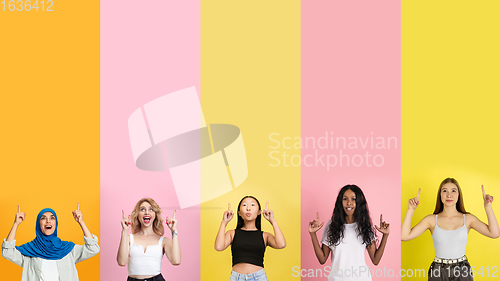 Image of Young people pointing up smiling on multicolored background. Human emotions, facial expression concept. Trendy colors. Creative collage.