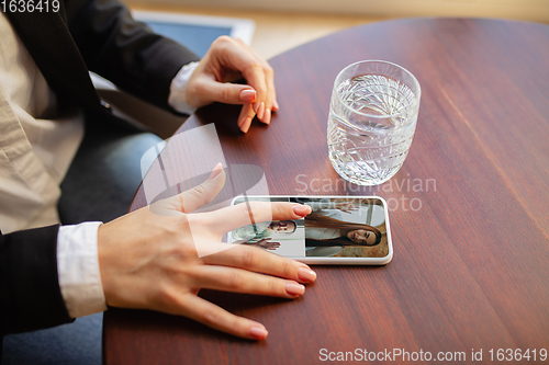 Image of Remote working. Workplace in bar, restaurant office with PC, devices and gadgets.