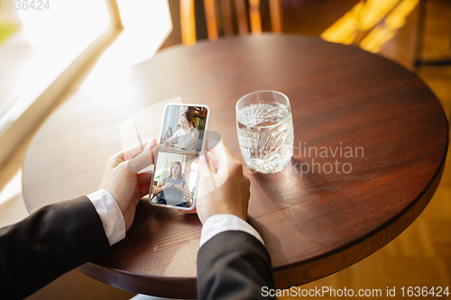 Image of Remote working. Workplace in bar, restaurant office with PC, devices and gadgets.