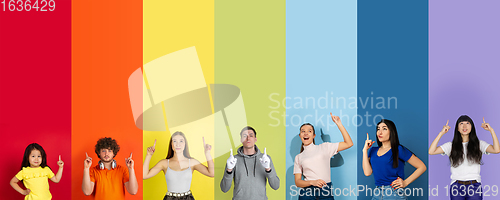 Image of Young people pointing up smiling on multicolored background. Human emotions, facial expression concept. Trendy colors. Creative collage.