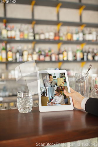 Image of Remote working. Workplace in bar, restaurant office with PC, devices and gadgets.