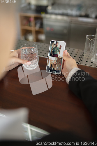 Image of Remote working. Workplace in bar, restaurant office with PC, devices and gadgets.