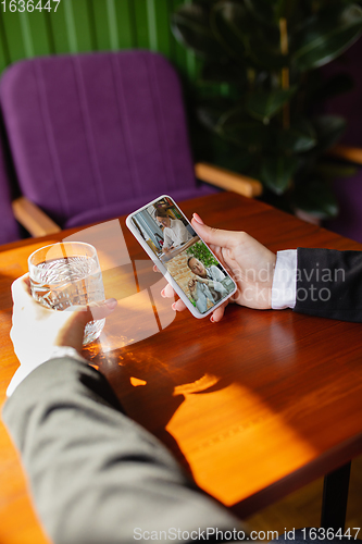 Image of Remote working. Workplace in bar, restaurant office with PC, devices and gadgets.