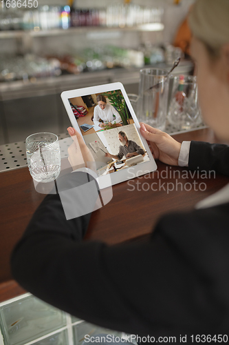 Image of Remote working. Workplace in bar, restaurant office with PC, devices and gadgets.