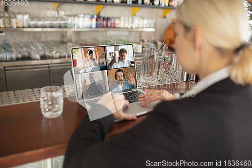 Image of Remote working. Workplace in bar, restaurant office with PC, devices and gadgets.